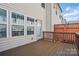 Exterior shot of a wooden deck, with a wooden fence, and a view of the back of the house at 7753 Jackson Pond Dr, Charlotte, NC 28273