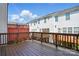 Exterior shot of a wooden deck, with a wooden fence, with a view of the back of the house at 7753 Jackson Pond Dr, Charlotte, NC 28273