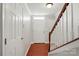 Inviting foyer with hardwood floors, white walls, staircase with wooden handrail, and a white front door at 7753 Jackson Pond Dr, Charlotte, NC 28273