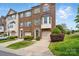 Beautiful three-story brick townhome with a manicured lawn and attached garage at 7753 Jackson Pond Dr, Charlotte, NC 28273
