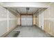 Clean, unfinished garage with white door and concrete floor ready for customization at 7753 Jackson Pond Dr, Charlotte, NC 28273