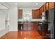Stylish kitchen featuring wood cabinets, black appliances, and granite countertops at 7753 Jackson Pond Dr, Charlotte, NC 28273