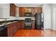 Traditional kitchen features wood cabinets, sleek black appliances, and durable countertops at 7753 Jackson Pond Dr, Charlotte, NC 28273