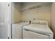 Functional laundry room equipped with modern white washer and dryer at 7753 Jackson Pond Dr, Charlotte, NC 28273