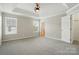 Light-filled main bedroom with carpeted floor and large window at 7753 Jackson Pond Dr, Charlotte, NC 28273
