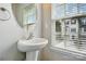 Chic powder room features a pedestal sink and large window with natural lighting at 7753 Jackson Pond Dr, Charlotte, NC 28273