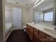 Bathroom with double vanity, a soaking tub, and wood-look floors at 8323 Carolina Laurel Ct, Charlotte, NC 28215