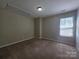 Neutral bedroom with plush carpet, a window, and ample space at 8323 Carolina Laurel Ct, Charlotte, NC 28215