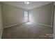 Well-lit bedroom features neutral carpet and a bright window at 8323 Carolina Laurel Ct, Charlotte, NC 28215