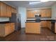 Spacious kitchen with stainless steel appliances, center island, and wood cabinets at 8323 Carolina Laurel Ct, Charlotte, NC 28215