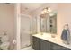 Well-lit bathroom featuring double vanity sinks, a glass-enclosed shower, and a modern toilet at 879 Park Slope Dr, Charlotte, NC 28209