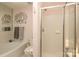 Modern bathroom with a soaking tub, glass shower, toilet, and artful towel and wall decor at 879 Park Slope Dr, Charlotte, NC 28209
