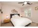 Cozy bedroom featuring a comfortable bed, ceiling fan, and natural light from the large windows at 879 Park Slope Dr, Charlotte, NC 28209