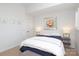 Comfortable bedroom featuring a white ceiling fan, big windows and an upholstered ottoman at 879 Park Slope Dr, Charlotte, NC 28209