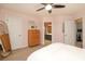 Spacious bedroom featuring a dresser, multiple closets, and a view of an adjacent bathroom at 879 Park Slope Dr, Charlotte, NC 28209