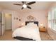 Bright bedroom featuring a comfortable bed, a ceiling fan, and natural light from the large windows at 879 Park Slope Dr, Charlotte, NC 28209