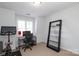 Bright home office featuring a desk, chair, shelving, and stationary bicycle at 879 Park Slope Dr, Charlotte, NC 28209