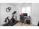 Functional home office with a desk, chair, stationary bicycle, and ample natural light at 879 Park Slope Dr, Charlotte, NC 28209