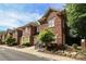 Brick townhome with well-maintained landscaping, and a side walk leading to the front door at 879 Park Slope Dr, Charlotte, NC 28209