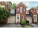 Charming brick townhome featuring a well-maintained front yard, attached garage, and welcoming entrance at 879 Park Slope Dr, Charlotte, NC 28209