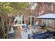 Brick patio featuring an outdoor seating area with chairs, an umbrella, and a view of the home's exterior at 879 Park Slope Dr, Charlotte, NC 28209