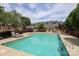 Outdoor community pool and lounge area surrounded by brick townhomes and lush landscaping at 879 Park Slope Dr, Charlotte, NC 28209