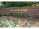 Landscaped brick sign reading 'HILLSIDE WEST' surrounded by colorful flowers and manicured greenery at 879 Park Slope Dr, Charlotte, NC 28209