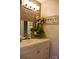 Bathroom featuring a white vanity, bronze faucet, and gray tiled backsplash at 920 Squirrel Hill Rd, Charlotte, NC 28213