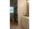 Bathroom including a white vanity, toilet, and shower with a floral curtain at 920 Squirrel Hill Rd, Charlotte, NC 28213