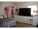 Bedroom featuring a TV, floral closet, and tile flooring at 920 Squirrel Hill Rd, Charlotte, NC 28213