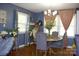 Charming dining room with a round table, elegant chandelier, and lots of natural light at 920 Squirrel Hill Rd, Charlotte, NC 28213