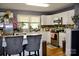 Bright kitchen with white cabinetry, stainless steel appliances, a kitchen island, and hardwood floors at 920 Squirrel Hill Rd, Charlotte, NC 28213