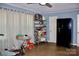 Living room featuring a black refrigerator, tile floors, and a ceiling fan at 920 Squirrel Hill Rd, Charlotte, NC 28213