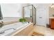 Bright bathroom features a soaking tub, separate shower, tile flooring and double door linen closet at 962 Blakeley Walk, Rock Hill, SC 29732