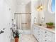 Bright bathroom featuring double vanity, shower-tub combination, and white cabinetry at 962 Blakeley Walk, Rock Hill, SC 29732