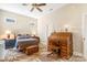 Spacious bedroom with a bed, wooden desk, ceiling fan, and carpeted floors at 962 Blakeley Walk, Rock Hill, SC 29732