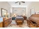 Bedroom featuring queen bed, roll-top desk, ceiling fan and neutral color scheme at 962 Blakeley Walk, Rock Hill, SC 29732
