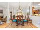 Elegant dining room featuring a chandelier, dining table with six chairs, and an adjacent open-concept living area at 962 Blakeley Walk, Rock Hill, SC 29732