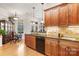 Bright, modern kitchen with wood cabinetry, granite countertops and black appliances at 962 Blakeley Walk, Rock Hill, SC 29732