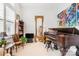 Bright living room with large windows, vintage chair, grand piano and decorative mirror at 962 Blakeley Walk, Rock Hill, SC 29732
