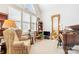 Bright living room with large windows, vintage chair, grand piano and decorative mirror at 962 Blakeley Walk, Rock Hill, SC 29732