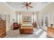 Inviting main bedroom suite with four poster bed, ceiling fan, and French doors to the patio at 962 Blakeley Walk, Rock Hill, SC 29732