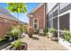 Charming brick patio with mature landscaping, water feature, seating and access to the sunroom at 962 Blakeley Walk, Rock Hill, SC 29732
