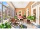 Inviting screened porch featuring brick walls, comfortable seating, and lush plants at 962 Blakeley Walk, Rock Hill, SC 29732