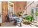 Relaxing screened porch with wicker furniture, a small table, and various plants at 962 Blakeley Walk, Rock Hill, SC 29732