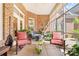 Cozy screened porch offers comfortable seating, brick accents, and leafy greenery at 962 Blakeley Walk, Rock Hill, SC 29732