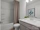 Well-lit bathroom showcases a shower-tub combo, vanity, and decorative art for a practical and stylish design at 10033 Guardian Dr # 265, Charlotte, NC 28273