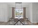 Bright dining room features modern lighting fixture, a wood table and beautiful views from the large window at 10033 Guardian Dr # 265, Charlotte, NC 28273