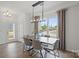 Bright dining room with a modern chandelier, large window, and views of the outdoors at 10033 Guardian Dr # 265, Charlotte, NC 28273