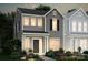 Charming two-story gray home with black shutters, front garden and a welcoming front door at 10033 Guardian Dr # 265, Charlotte, NC 28273